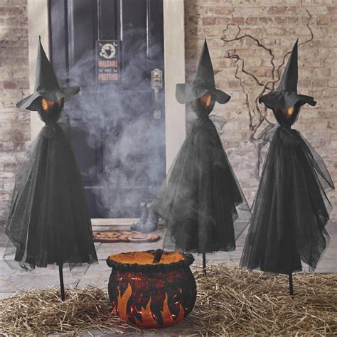 Witch figurine with stakes for halloween display
